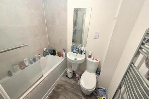 A well-designed bathroom featuring a bathtub an...