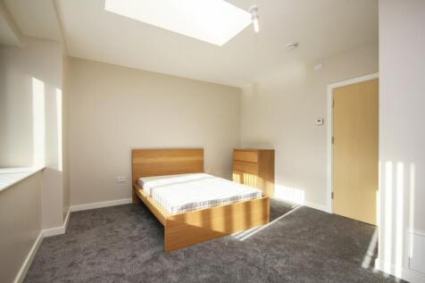 A bright and inviting double bedroom featuring ...