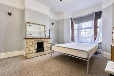 A spacious and bright master bedroom featuring ...