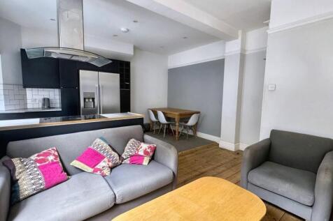 Bright and modern living room featuring a comfo...