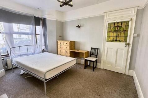 Bright double bedroom featuring a large bay win...