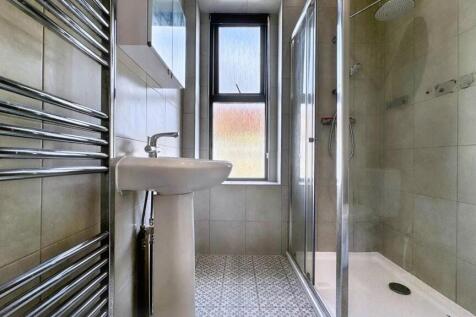 A modern bathroom featuring a spacious walk-in ...