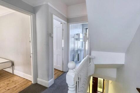 Bright and clean hallway featuring white walls ...