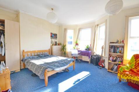 Bright and welcoming double bedroom featuring a...