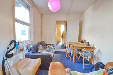 Bright living room featuring a comfortable seat...