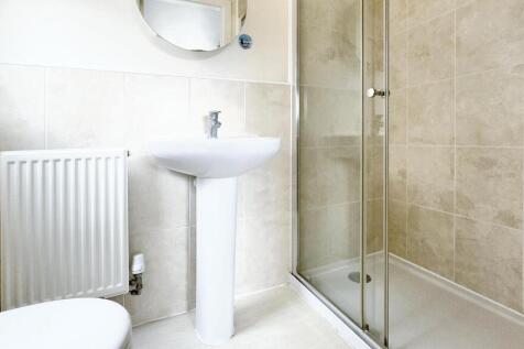 Bright and modern bathroom suite featuring a sp...