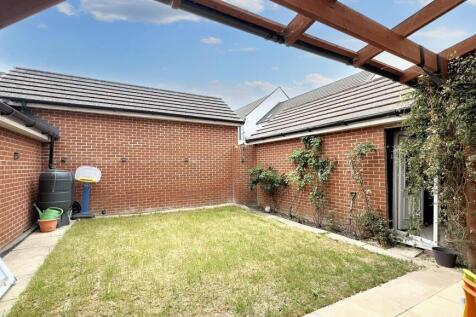 A bright and well-maintained garden featuring a...