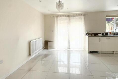 Bright and modern kitchen space featuring gloss...