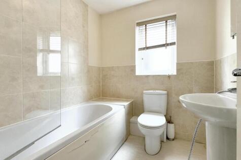 Bright and clean bathroom featuring a full-size...