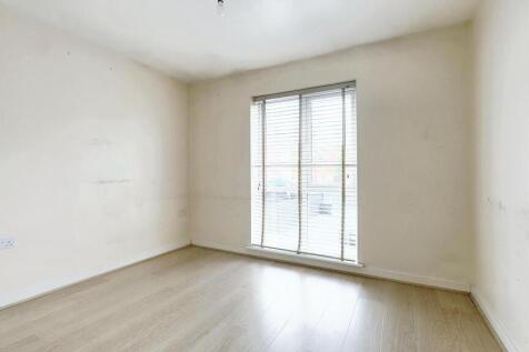 Bright and clean double bedroom with light wood...
