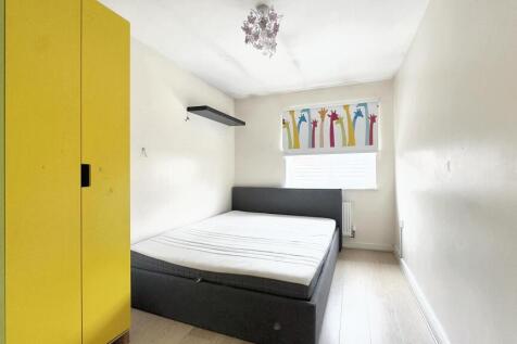 A clean and bright single bedroom featuring a c...
