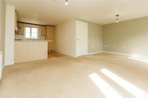 Bright and spacious living room with ample natu...