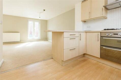 A bright and clean living area featuring light ...