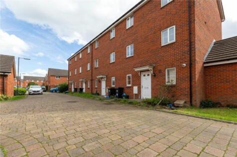 A modern terraced brick house featuring multipl...