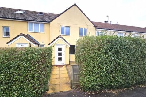 A well-maintained terraced house with a neat fr...