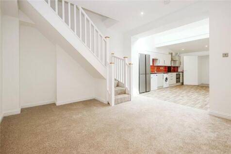 Bright and spacious living room featuring clean...