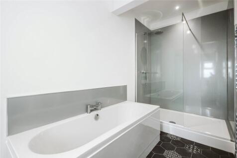 A modern, clean bathroom suite featuring a spac...