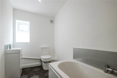Bright and clean bathroom featuring a modern ba...