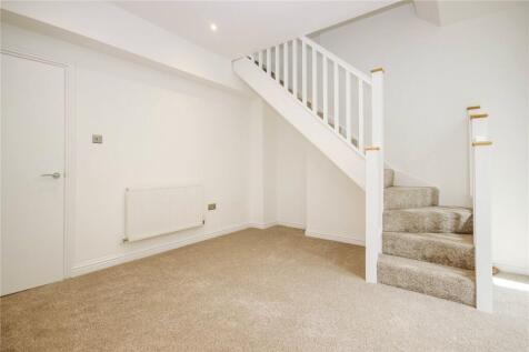 Bright and clean hallway featuring a neutral ca...