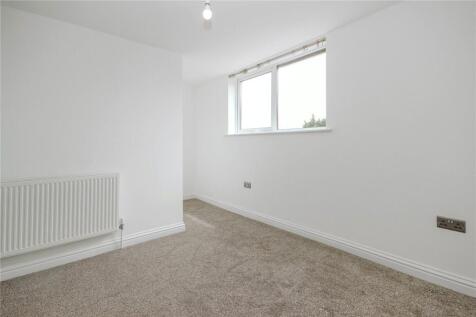 Bright and clean single bedroom featuring neutr...