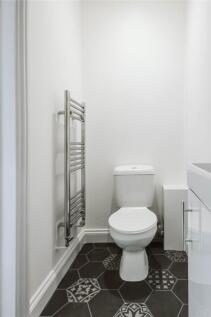 A modern and clean single toilet room featuring...