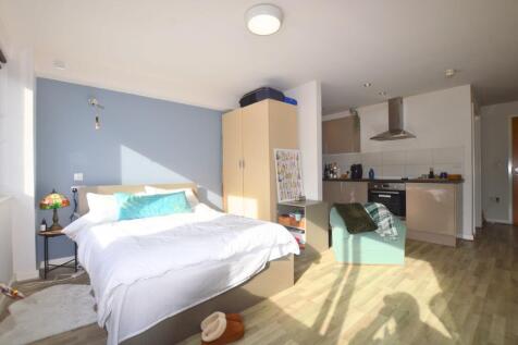 Bright and spacious master bedroom with a comfo...