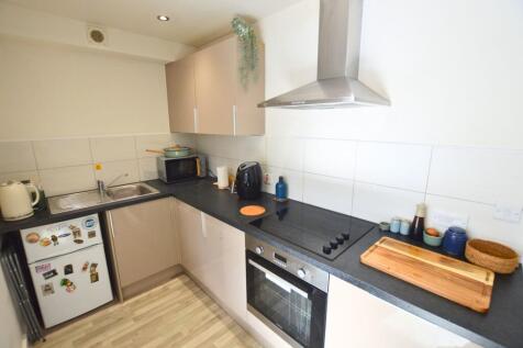 Modern kitchen with sleek beige cabinets, integ...