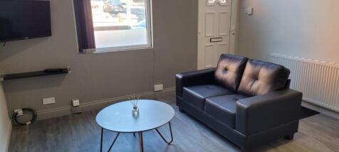 A modern living room featuring a comfortable bl...