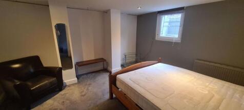 A cozy double bedroom featuring a comfortable w...