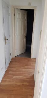 A clean and well-maintained hallway featuring p...