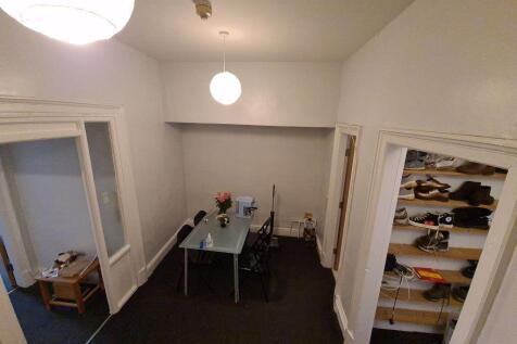 A modest communal workspace featuring a central...