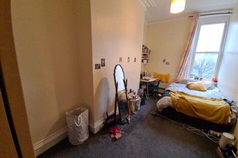 Cozy single bedroom featuring a comfortable bed...