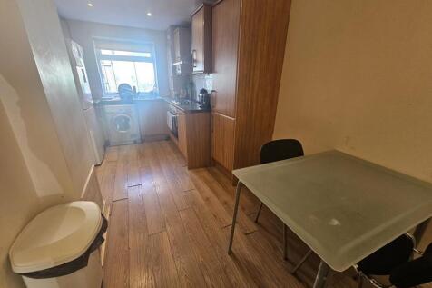 A neat and functional kitchen featuring wooden ...