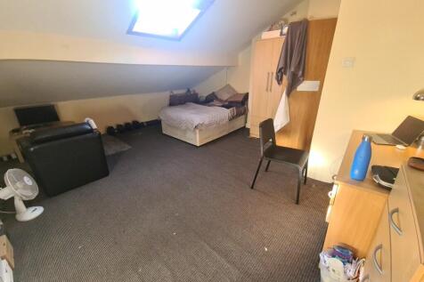 Cozy attic bedroom featuring a comfortable doub...