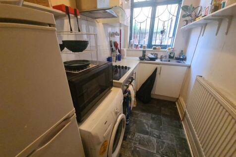 Compact kitchen space featuring essential appli...