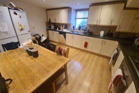 A spacious and well-equipped kitchen featuring ...