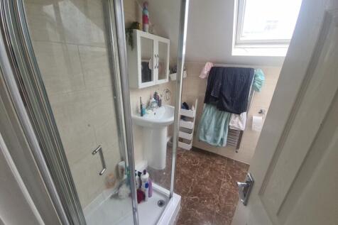 A clean and modern bathroom featuring a glass s...