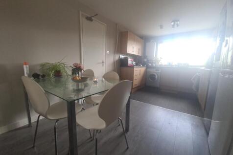 A bright and tidy kitchen featuring a glass din...