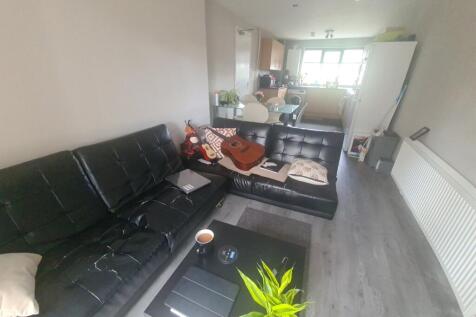 Contemporary living room featuring a sleek blac...