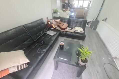 A comfortable living room featuring a large bla...