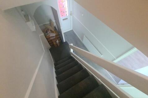 Bright and clean staircase with carpeted steps,...