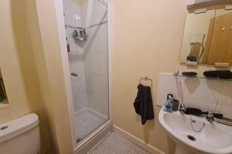 A neat and functional bathroom featuring a corn...