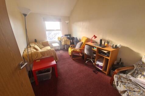Cozy single bedroom featuring a comfortable bed...