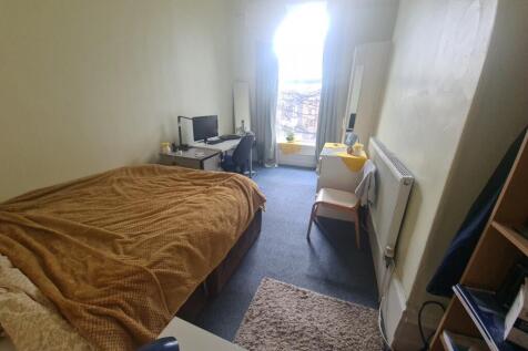 Cozy single bedroom with a comfortable bed, a d...