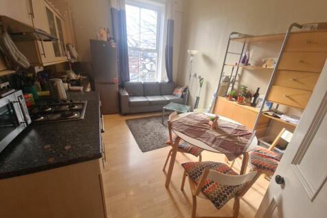 A bright and welcoming kitchen featuring wooden...