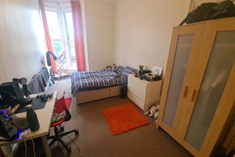 Bright and cozy single bedroom featuring a larg...