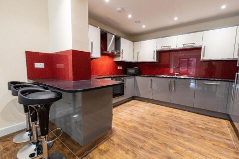 Modern kitchen with sleek grey and white cabine...