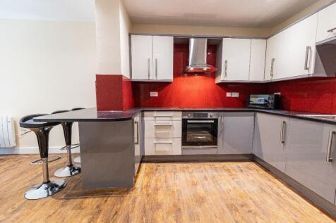 Modern kitchen with sleek grey cabinetry, a vib...