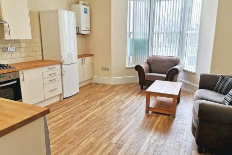 Spacious and bright living room featuring large...