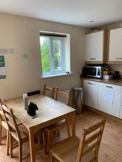 A bright and tidy kitchen area featuring a wood...